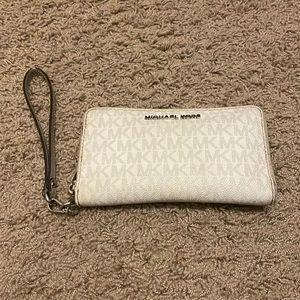 Used white Michael Kors wristlet- metal piece broke, but reattached